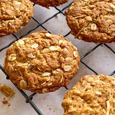 Golden Anzac biscuits on a cooling rack
