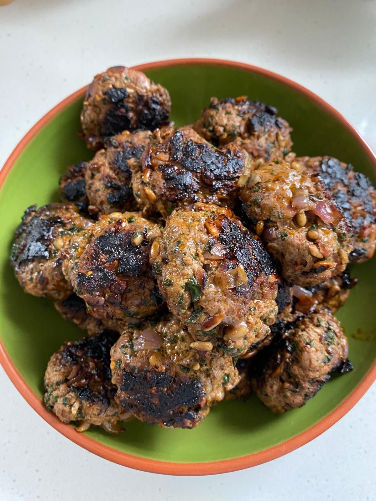 Homemade beef rissoles in a bowl