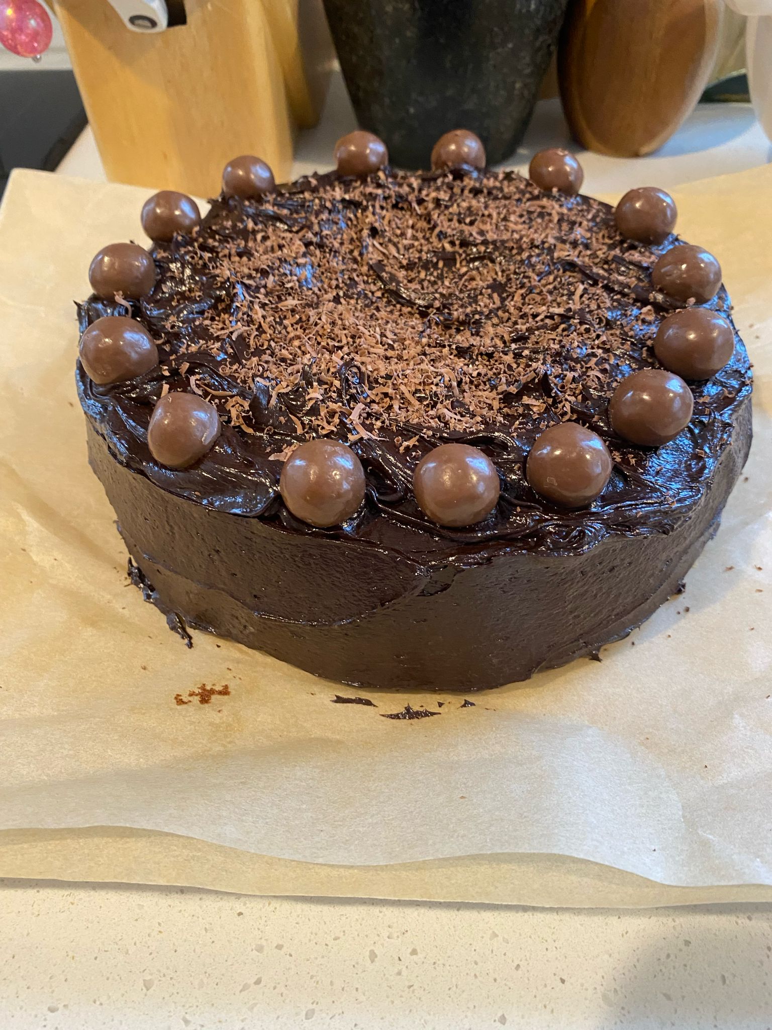Rich chocolate cake topped with Maltesers and ganache