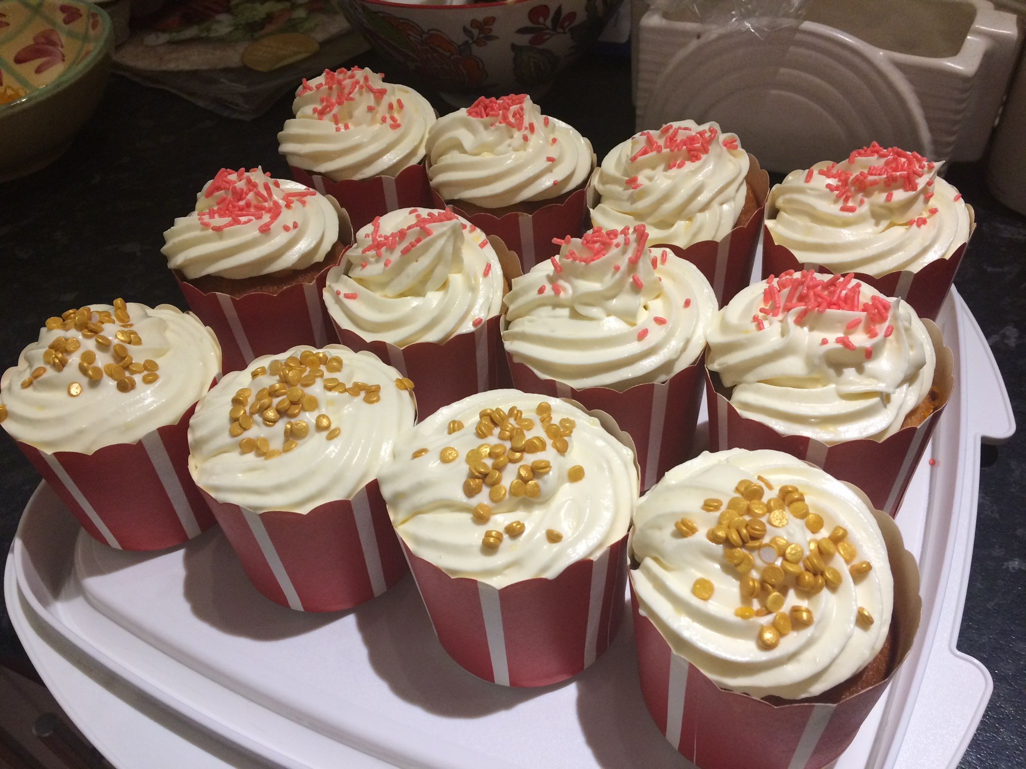 Lemon syrup cupcakes with white frosting and sprinkles