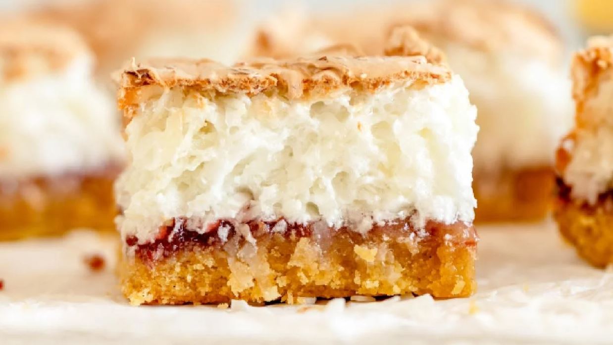 Louise cake slice showing pastry base, raspberry jam and coconut meringue
